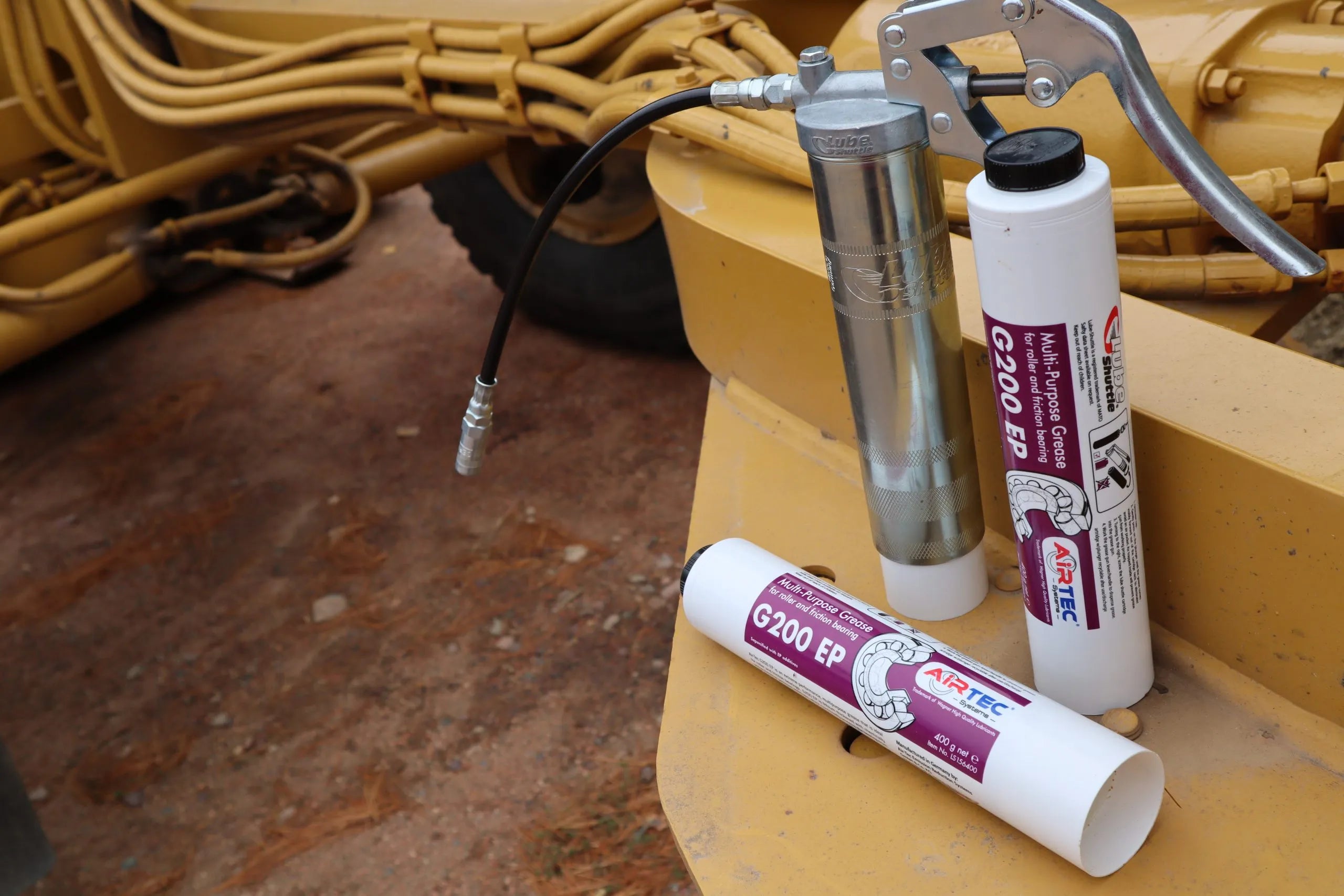 Two Multi-purpose Grease and a grease gun placed in the tractor